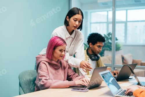 Preview: young programmers working on a new project for a start up business.