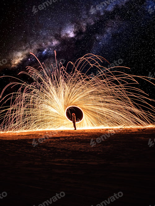 Preview: A stunning shot of a man spinning steel wool under a starry night sky.