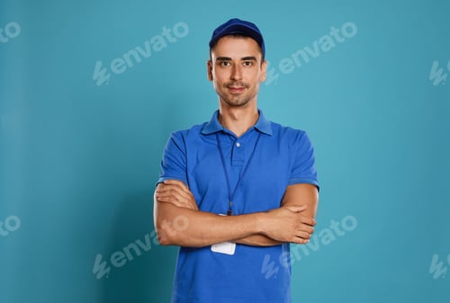 Preview: Portrait of happy young courier on blue background