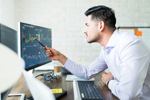Preview: Handsome Young Male Trader Examining Stock Market