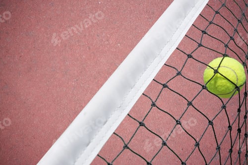 Preview: Tennis Ball In Net On Court Background