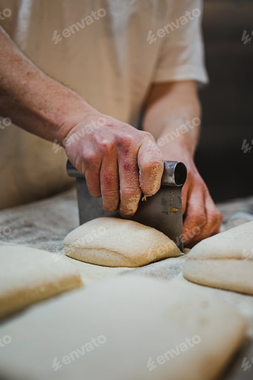 Preview: Baker cutting bread dough