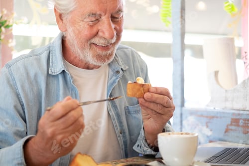 Preview: Adult senior man in coffee shop having breakfast with cappuccino and sweet food. Smiling elderly peo