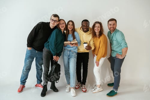 Preview: Positive friends. Group of young people are standing against white background