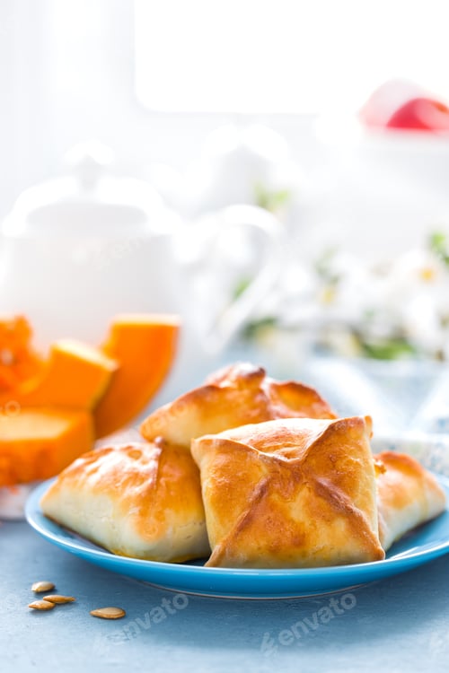 Preview: Delicious homemade baking. Patties with fresh pumpkin on white background, closeup