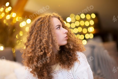 Preview: Beauty model woman with beautiful make up and curly hair style over holiday lights background