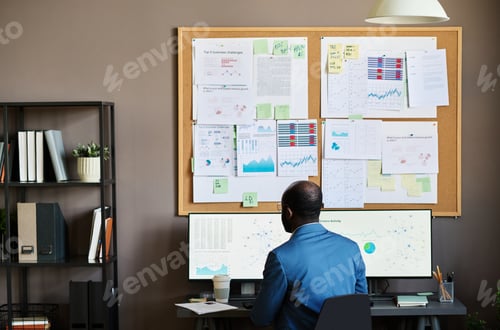 Preview: Businessman examining graphs on computer