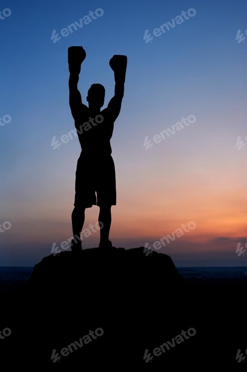 Preview: Dark silhouette of a muscular male boxer outdoors on sunset