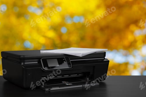 Preview: Compact laser printer on black desk against blurred background