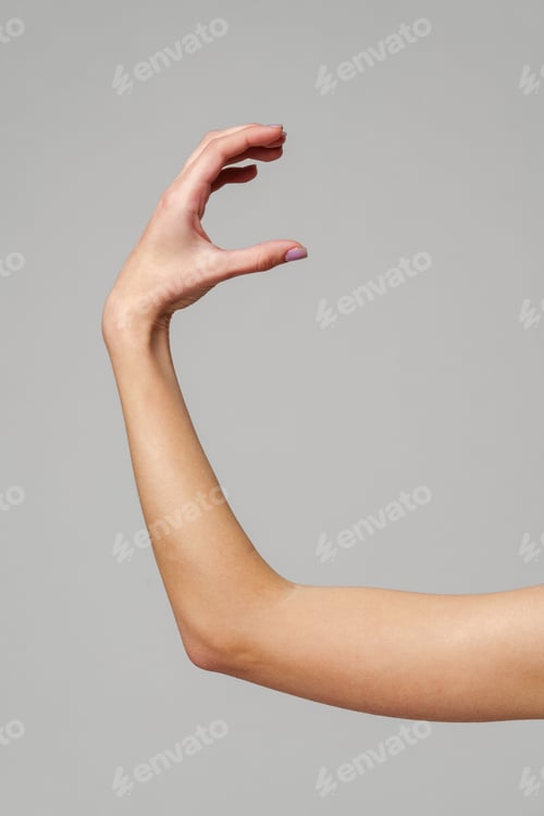 Preview: Female hand sign against gray background in studio