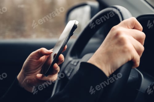 Preview: Driver Using Mobile Phone While Holding Steering Wheel