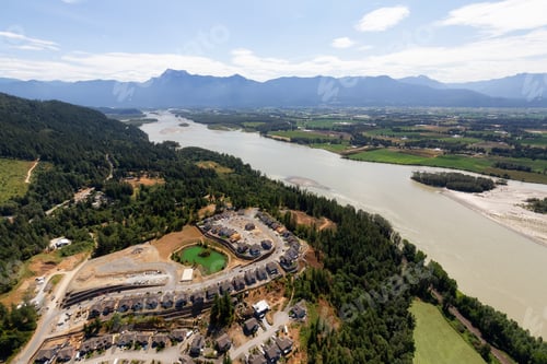 Preview: Aerial View of Residential Homes and Construction Site on a hill