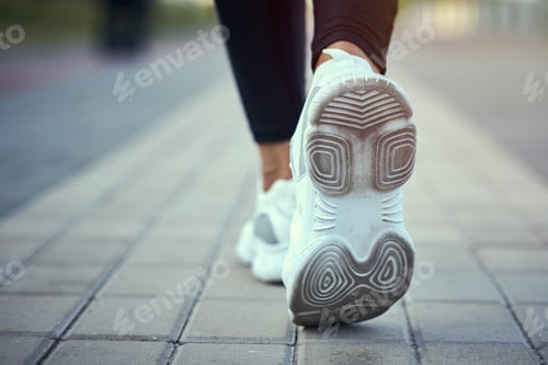 Preview: Back view of runner in a sport sneakers running outdoors, clothe up