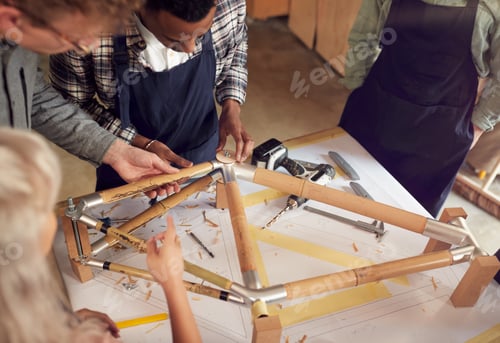Preview: Multi-Cultural Team In Workshop Assembling Hand Built Sustainable Bamboo Bicycle Frame