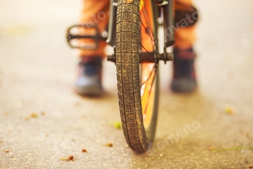 Preview: Boy with a bicycle on the street. wheel of a children's bicycle