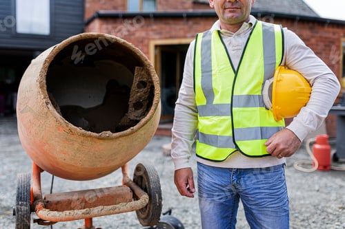 Preview: Contractor next to a cement mixer