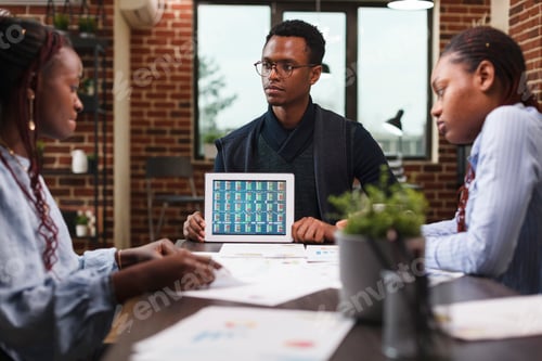 Preview: Business company marketing team leader presenting team financial data on modern tablet