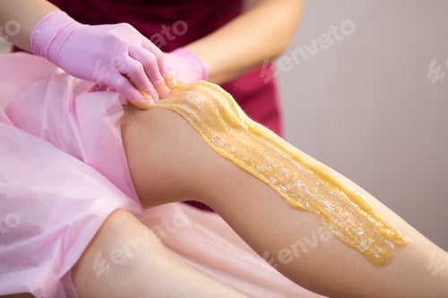 Preview: Sugar depilation of the feet in the beauty salon. Rid of hair on the legs. Sugaring. Master