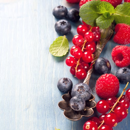 Preview: Berries and vintage spoon on a blue background