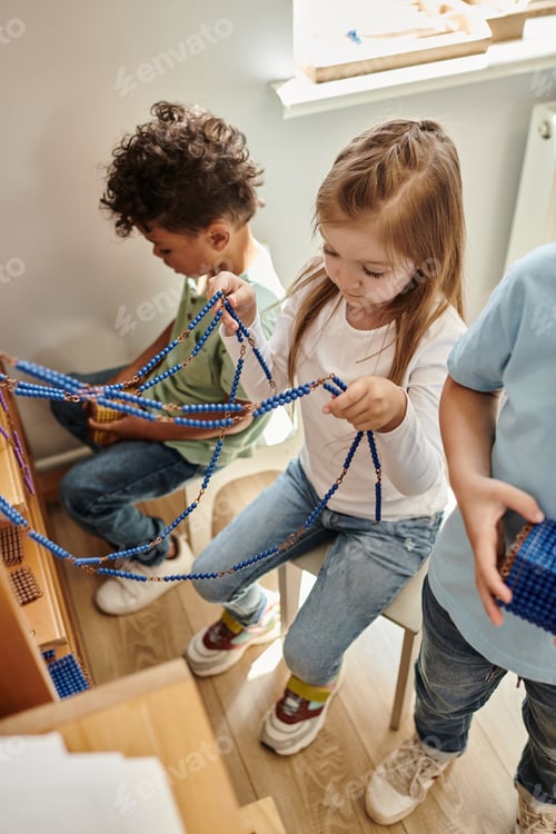Preview: smart girl playing with Montessori pearl beads material, learn math, interracial kids, diversity