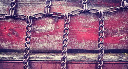 Preview: Vintage stylized chains on old wooden wall.