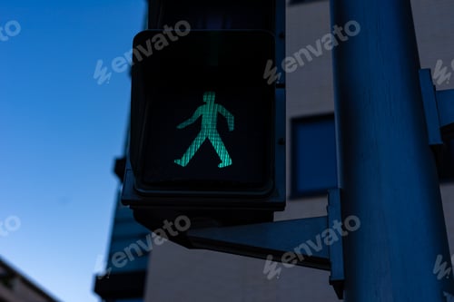 Preview: Low angle shot of green traffic light on the street at daytime
