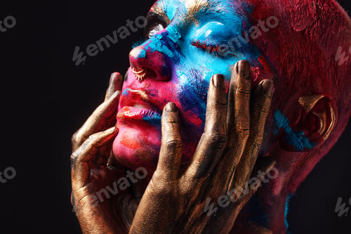 Preview: Shot of an attractive young woman posing alone in the studio with paint on her face