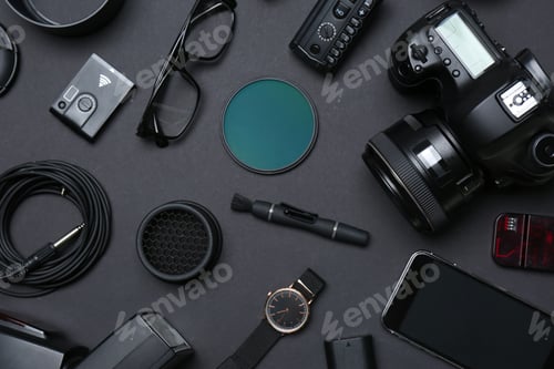 Preview: Flat lay composition with equipment for professional photographer on dark background