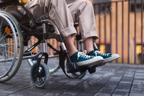 Preview: Close up of young gen Z boy in a wheelchair in the city.
