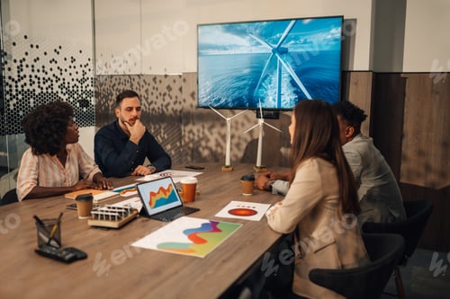Preview: Interracial team at boardroom discussing sustainability on a meeting.