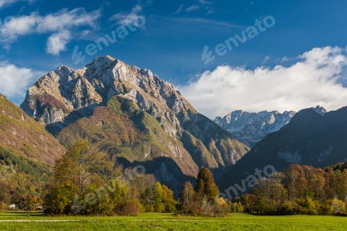 Preview: Vibrant green meadow and high Alps in Slovenia