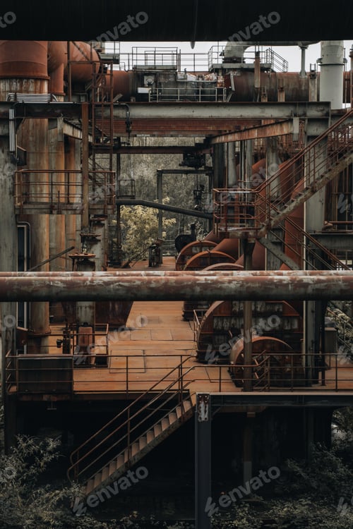 Preview: Abandoned industrial factory with rusty metal structures and overgrown vegetation