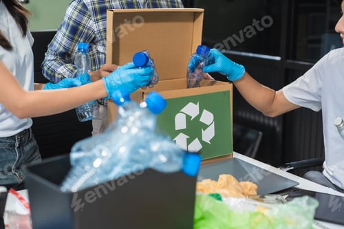 Preview: Business people working examining waste recyclable separation divided bin in the office