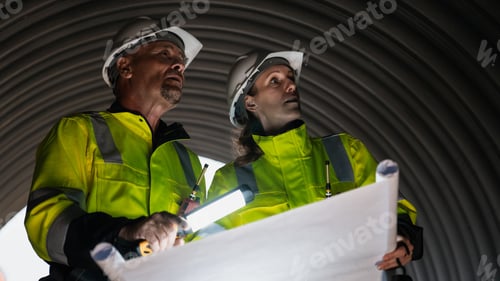 Preview: Worker constructing a pipeline for transporting oil, gas, and fuel at an industrial facility.