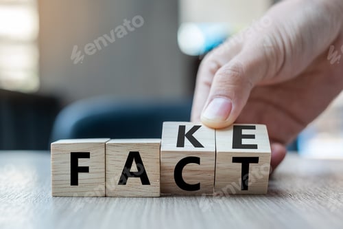 Preview: Business man hand holding wooden cube with flip over block FAKE to FACT