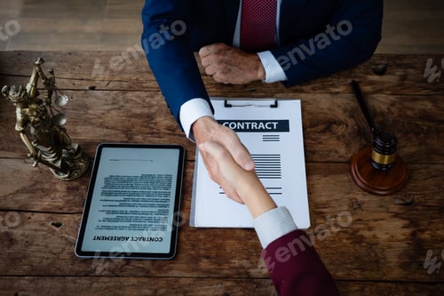 Preview: Lawyers shaking hands in agreement after signing contract