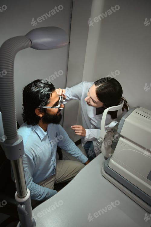 Preview: Ophthalmologist checking eye vision of patient for spectacles glasses.