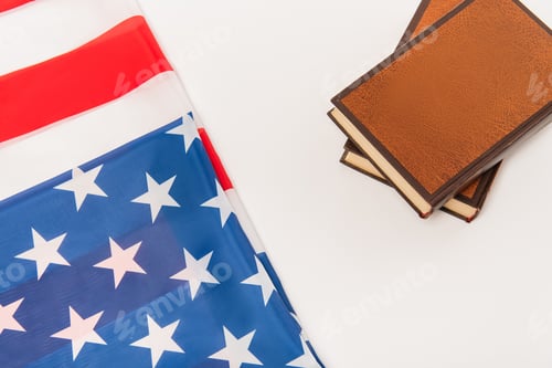 Preview: top view of american flag near books isolated on white