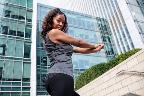 Preview: Fitness mature black woman stretching.