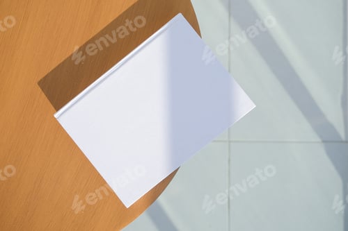 Preview: book cover mockup design. blank book mockup on wooden coffee table , shadow overlay