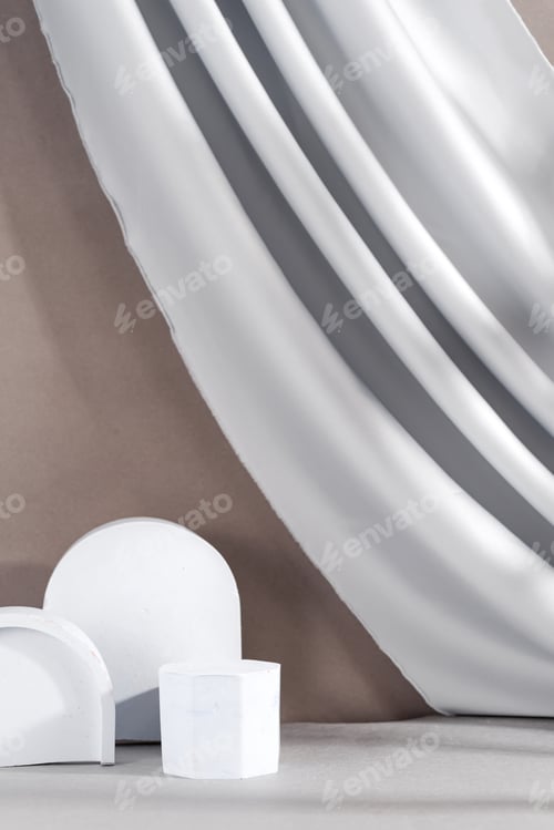 Preview: Different geometric pedestals with fabric drapery on pastel background