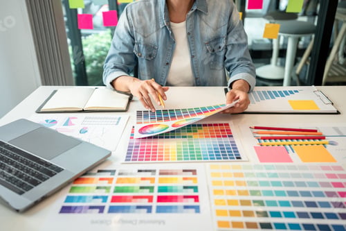 Preview: Young creative graphic designer working on color selection and drawing on graphics tablet