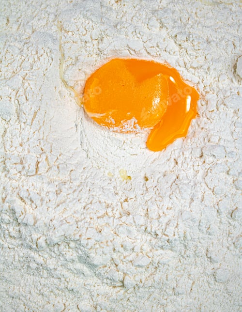 Preview: Cooking homemade cakes. Raw egg in a bunch of flour.