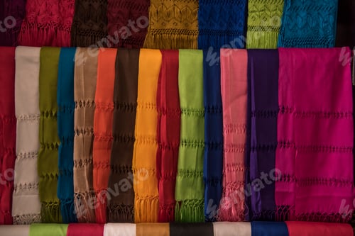 Preview: A colorful array of scarves are displayed on a table
