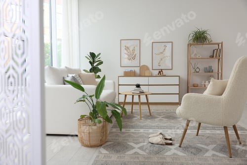 Preview: Stylish sofa and other furniture in living room. Interior design