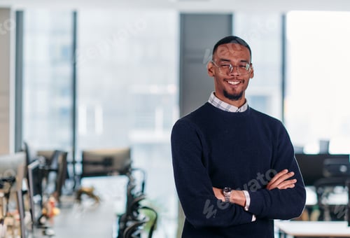 Preview: Confident African American Businessman Posing in Modern Startup Office.