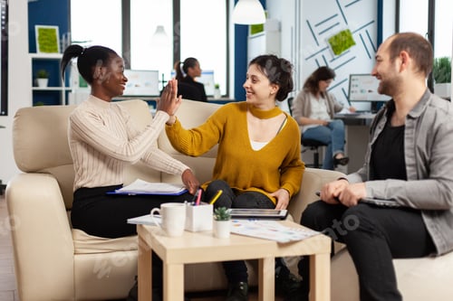 Preview: Confident company manager giving working tasks to diverse teammates
