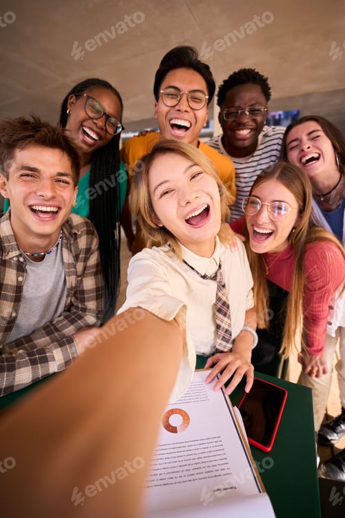 Preview: A large group of smiling and cheerful young multiracial university students taking a selfie
