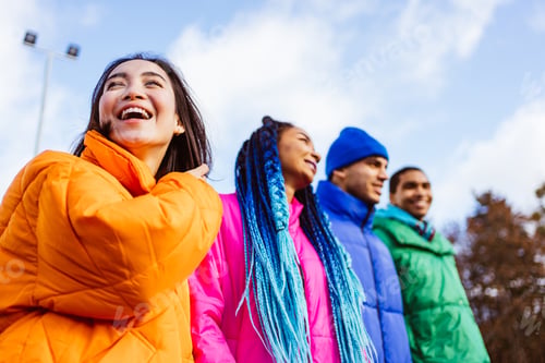 Preview: Multiracial group of young friends meeting outdoors in winter