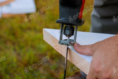 Preview: Handmade carpenter engaged in processing wood in the jigsaw
